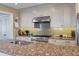 Close-up kitchen view with granite countertops, stainless steel appliances, and a sleek backsplash at 1235 Sunset Dr, Charleston, SC 29407