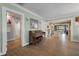 Open-concept living room leads to a light filled kitchen and features an upright piano on hardwood floors at 1235 Sunset Dr, Charleston, SC 29407