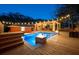 Inviting backyard with a beautiful pool, fire features, and a covered patio with string lights at 1235 Sunset Dr, Charleston, SC 29407