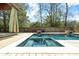 A backyard pool with a seating area, surrounded by lush greenery, offering a refreshing escape at 1235 Sunset Dr, Charleston, SC 29407