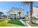 Beautiful backyard features a screened-in porch, well-maintained lawn, and mature palm trees at 125 Gaslight Blvd, Summerville, SC 29483