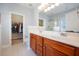 Elegant bathroom with double sinks, cherry cabinets, and walk-in closet at 125 Gaslight Blvd, Summerville, SC 29483