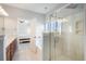 Bright bathroom featuring glass enclosed shower, bathtub, and view into the primary bedroom at 125 Gaslight Blvd, Summerville, SC 29483