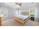 Bright bedroom with plush carpeting, stylish fan, and natural light from multiple windows offering water views at 125 Gaslight Blvd, Summerville, SC 29483