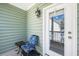 Cozy porch features exterior chair and table with a view of the yard at 125 Gaslight Blvd, Summerville, SC 29483