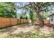 Large, fenced backyard with mature tree, a play structure, and a fire pit at 1302 Aubry Dr, Moncks Corner, SC 29461