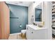This bathroom includes a white vanity, beige tile floors, and an accent wall with modern fixtures at 1302 Aubry Dr, Moncks Corner, SC 29461