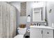 Well-lit bathroom with gray walls, white vanity, and decorative wall art at 1302 Aubry Dr, Moncks Corner, SC 29461