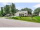 Inviting home with a manicured lawn and mature trees. A white exterior with a garage at 1302 Aubry Dr, Moncks Corner, SC 29461