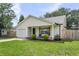 Single story home features a welcoming front porch with seating and well-manicured landscaping at 1302 Aubry Dr, Moncks Corner, SC 29461