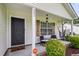 Inviting front porch with cozy seating and a hanging hammock, perfect for relaxing outdoors at 1302 Aubry Dr, Moncks Corner, SC 29461