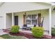 Charming front porch with seating and a hammock, complemented by tasteful landscaping at 1302 Aubry Dr, Moncks Corner, SC 29461