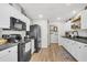Updated kitchen with white cabinets, modern appliances, and ample countertop space at 1302 Aubry Dr, Moncks Corner, SC 29461