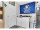 Spacious laundry room with full-size washer and dryer, a blue banner, and a shelving unit at 1302 Aubry Dr, Moncks Corner, SC 29461