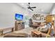 Bright living room featuring a sectional sofa, TV, and access to the outdoor patio at 1302 Aubry Dr, Moncks Corner, SC 29461