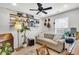 This living room has a cozy couch, open shelving for books, wood floors, and a decorative floor lamp at 1302 Aubry Dr, Moncks Corner, SC 29461