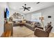 Cozy living room featuring a large sectional sofa, a ceiling fan, and natural light at 1302 Aubry Dr, Moncks Corner, SC 29461