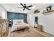 This main bedroom offers bright and airy decor, with wood floors, an accent wall, and floating shelves at 1302 Aubry Dr, Moncks Corner, SC 29461