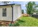 Side yard featuring a green lawn, white siding, a wood fence, and a glimpse of the neighborhood at 1302 Aubry Dr, Moncks Corner, SC 29461