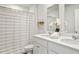 Well-lit bathroom featuring double sinks, modern fixtures, and a stylish shower curtain at 141 Haventree Ct, Summerville, SC 29486