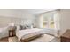 Sunlit bedroom with a wood frame bed, accent wall, and comfortable area rug at 141 Haventree Ct, Summerville, SC 29486