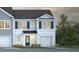 Charming two-story home with blue shutters, white siding, attached garage, and landscaping at 141 Haventree Ct, Summerville, SC 29486
