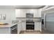 Stylish kitchen with stainless steel appliances, granite counters, and white cabinets at 141 Haventree Ct, Summerville, SC 29486