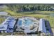 Gorgeous aerial view of community pool featuring palm trees, lounge chairs, and nearby pond at 157 Pocket Bend Cir, Summerville, SC 29486