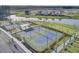Aerial view of tennis courts, a pond, and new home construction in a planned community at 157 Pocket Bend Cir, Summerville, SC 29486