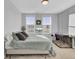 Bright bedroom featuring light gray walls, plush bedding, and large windows with views at 157 Pocket Bend Cir, Summerville, SC 29486