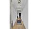 Elegant hallway with hardwood floors, stylish lighting fixtures, and neutral wall colors, leading to the living areas at 157 Pocket Bend Cir, Summerville, SC 29486