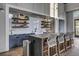 Stylish kitchenette with floating shelves, tile backsplash, sink and bar seating at 157 Pocket Bend Cir, Summerville, SC 29486