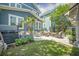 Large outdoor area with a stone patio, seating, hot tub, and lush greenery at 1588 Paradise Lake Dr, Mount Pleasant, SC 29464