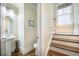 Bathroom and staircase view featuring stylish pedestal sink and hardwood stairs at 1588 Paradise Lake Dr, Mount Pleasant, SC 29464