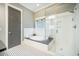 Bright bathroom offers a modern shower and tub combo with stylish black and white tile flooring at 1588 Paradise Lake Dr, Mount Pleasant, SC 29464