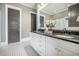 Elegant bathroom features a double vanity with black countertops and stylish black and white tile flooring at 1588 Paradise Lake Dr, Mount Pleasant, SC 29464