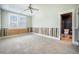 Bright bedroom features neutral carpet, ceiling fan, natural light, and ensuite bathroom with tile floors at 1588 Paradise Lake Dr, Mount Pleasant, SC 29464