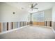 Bright bedroom features neutral carpet, ceiling fan, natural light, and wood paneled wainscotting at 1588 Paradise Lake Dr, Mount Pleasant, SC 29464