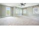 Bright bedroom features neutral carpet, ceiling fan, natural light, and access to covered porch at 1588 Paradise Lake Dr, Mount Pleasant, SC 29464