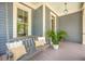 Comfortable front porch offers a relaxing swing adorned with cushions, creating a cozy outdoor retreat at 1588 Paradise Lake Dr, Mount Pleasant, SC 29464