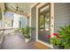 Inviting front porch features classic door, potted plants, and ceiling fan at 1588 Paradise Lake Dr, Mount Pleasant, SC 29464