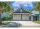 Exterior of a detached two-car garage with white carriage doors and manicured lawn at 1588 Paradise Lake Dr, Mount Pleasant, SC 29464