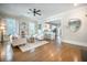 Bright living room boasts beautiful hardwood floors and seamless flow into the adjacent kitchen at 1588 Paradise Lake Dr, Mount Pleasant, SC 29464
