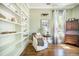 Relaxing living room with built-in shelves, hardwood floors, and a cozy chair near a bright window at 1588 Paradise Lake Dr, Mount Pleasant, SC 29464