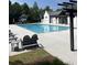 Inviting pool area with ample seating, a well-maintained deck, and a charming cabana, ideal for outdoor entertaining and relaxation at 1588 Paradise Lake Dr, Mount Pleasant, SC 29464