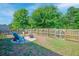 Cozy backyard featuring a fire pit, Adirondack chair, and charming wood fence at 1589 Seabago Dr, Charleston, SC 29414