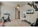 Angle view of an exercise room with a TV, mirror, workout equipment and a three-door closet at 1589 Seabago Dr, Charleston, SC 29414