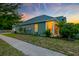 Exterior of home with green siding and a cozy front porch, nestled in a tranquil neighborhood at 1589 Seabago Dr, Charleston, SC 29414