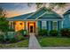 Exterior front of a home with lush greenery, front porch decor and a charming neighborhood vibe at 1589 Seabago Dr, Charleston, SC 29414