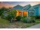 Quaint home with a welcoming porch and well-maintained landscaping at sunset at 1589 Seabago Dr, Charleston, SC 29414